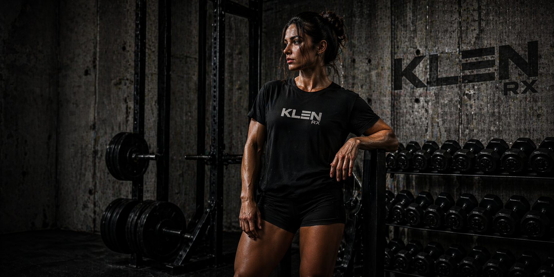 Person wearing a black KLEN RX t-shirt in a gym setting