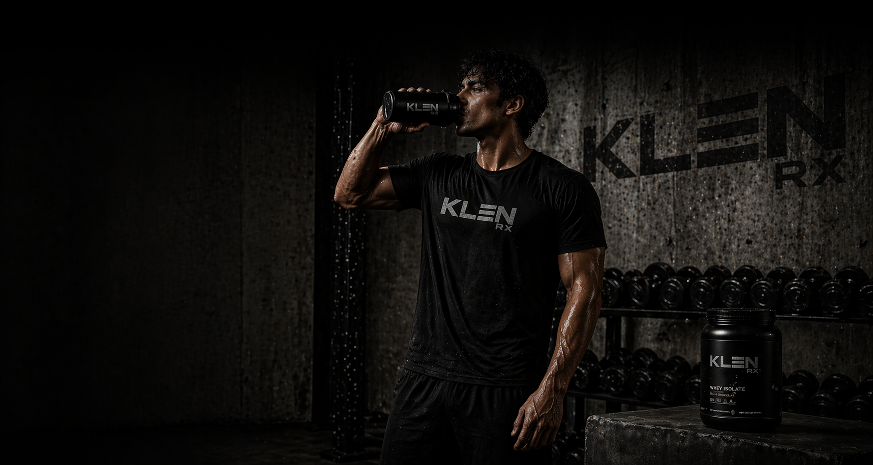 Person drinking from a KLEN bottle in a gym setting